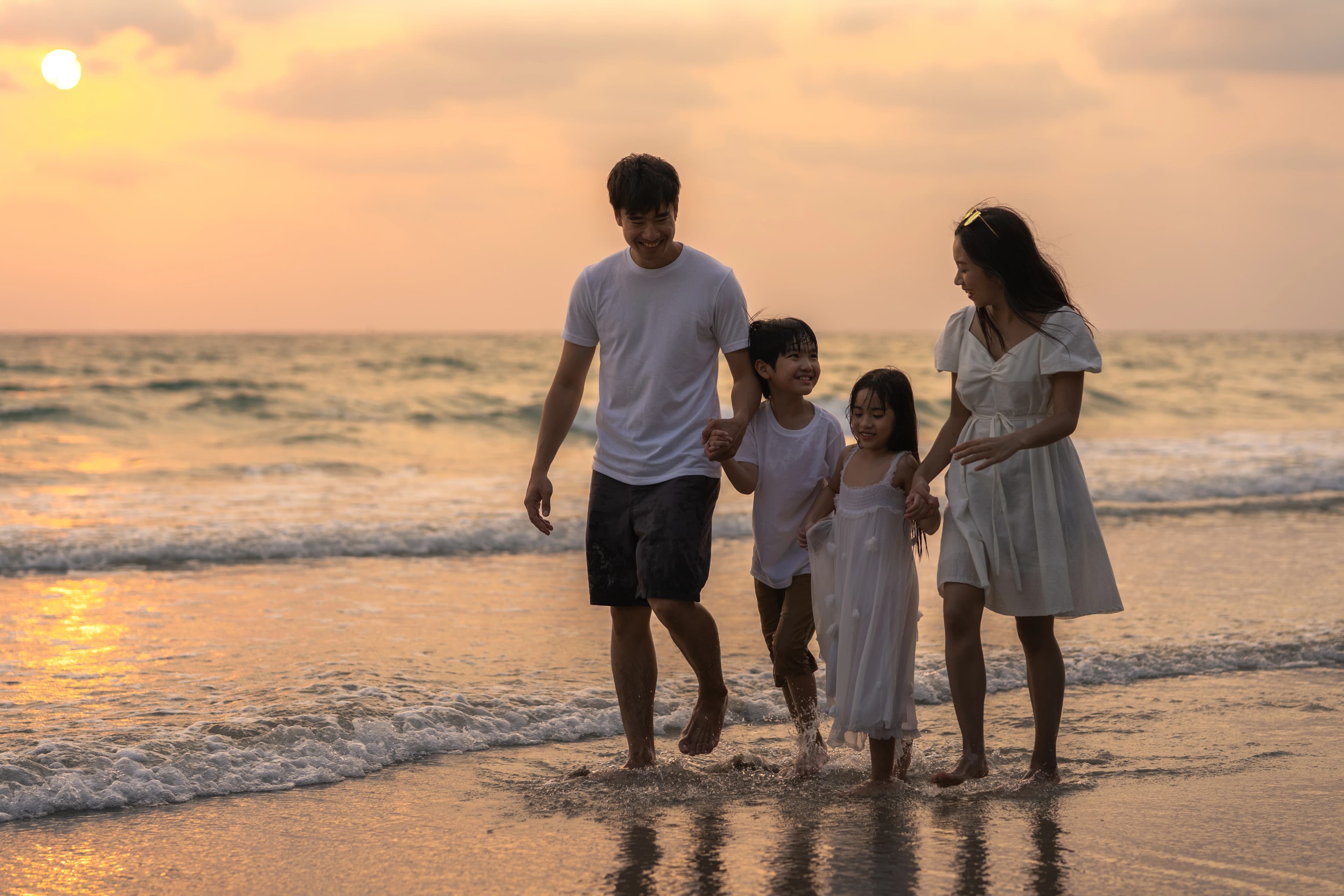 Filipino family walking on the beach